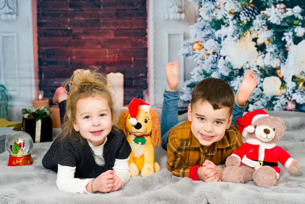 Deux enfants complices pendant une séance photo de Noël au studio à Limoges