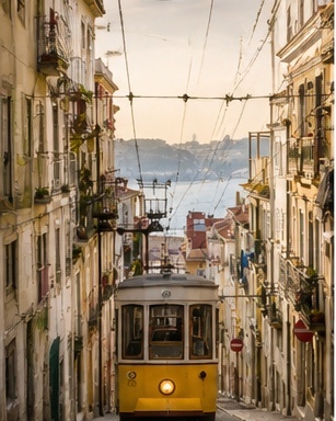 Tramway dans Alfama avec vue vers le Tage, repère iconique pour un reportage de mariage à Lisbonne.