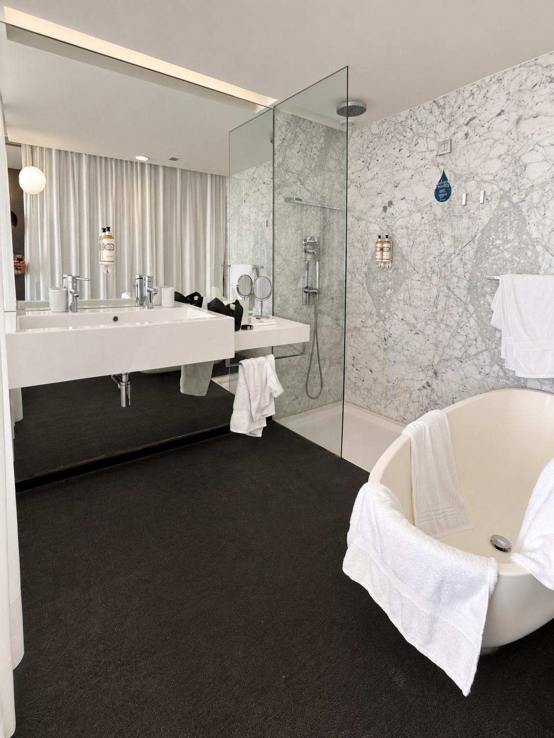 Salle de bains lumineuse avec douche vitrée et baignoire